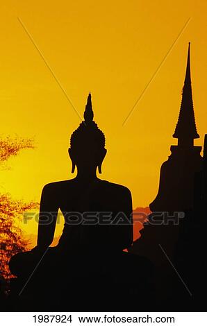 Picture - Thailand, Sukhothai, Buddha And Temple Silhouetted At Sunset, Orange Sky. Fotosearch