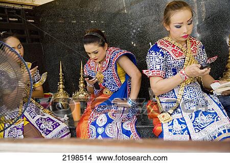 Picture - Thailand, Thai Dancers On Phone In Erawan Shrine; Bangkok. Fotosearch