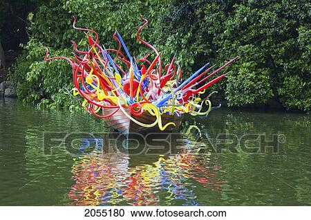 Stock Image - Thames Skiff By Dale Chihuly In Front Of The Palm House Royal Botanic Gardens, Kew, Surrey, England, United Kingdom. Fotosearch