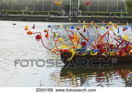 Stock Photo - Thames Skiff By Dale Chihuly In Front Of The Palm House Royal Botanic Gardens, Kew, Surrey, England, United Kingdom. Fotosearch