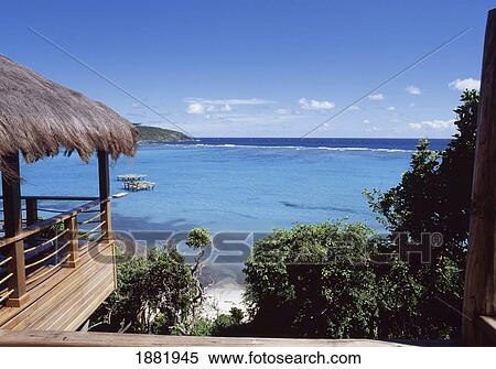 Stock Photography - Thatched Roof Over Balcony Overlooking Sea. Fotosearch
