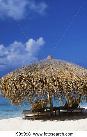 Thatched Umbrella On Beach Two Chairs, Bright Blue Sky, White Sand, Blue Ocean View Large Photo Image Stock Photo - Thatched Umbrella On Beach Two Chairs, Bright Blue Sky, White Sand, Blue Ocean. Fotosearch