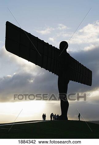 Stock Image - The Angel Of The North Sculpture With Tourists At Dusk. Fotosearch