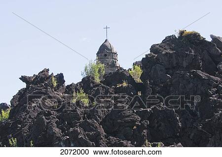 Stock Image - The Bell Tower Of The San Juan Parangaricutiro Church Sticks Out Through The Paricut. Fotosearch