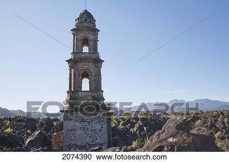 Stock Image - The Bell Tower Of The San Juan Parangaricutiro Church Sticks Out Through The Paricut. Fotosearch