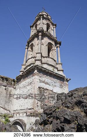 Stock Photograph - The Bell Tower Of The San Juan Parangaricutiro Church Destroyed By The Paricut. Fotosearch
