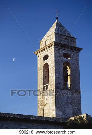 Stock Photo - The Belltower Of The Church Of Santo Stefano Di Sessanio With The Moon Behind At Dusk, Abruzzo, Italy.. Fotosearch