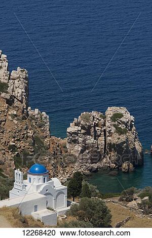 Stock Image - The blue domed church at the water's edge; Panayia Poulati, Sifnos, Cyclades, Greek Islands, Greece. Fotosearch