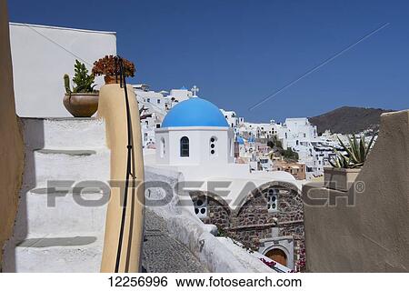 The blue domed Church of St. Nicholas and bougainvillea around stairs; Oia, Santorini, Cyclades, Greek Islands, Greece View Large Photo Image Stock Photograph - The blue domed Church of St. Nicholas and bougainvillea around stairs; Oia, Santorini, Cyclades, Greek Islands, Greece. Fotosearch