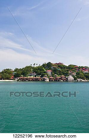 Stock Photograph - The boat ride from Ko Pha Ngan to Ko Samui, with a view a Haad Rin beach along the shore; Thailand. Fotosearch