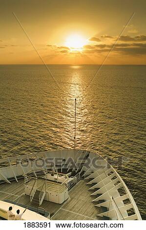 Stock Image - The Bow Of A Boat On The Caribbean At Sunset; Bahamas. Fotosearch