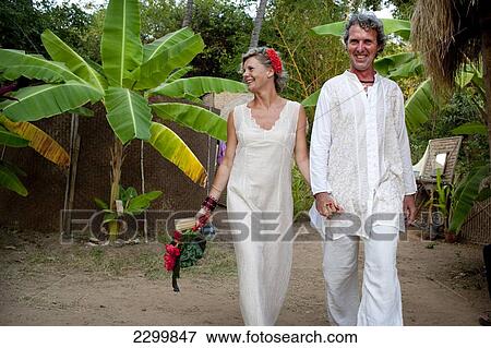 Stock Photo - The Bride and groom arrive at Harmonic Healing Centre for their spiritual wedding ceremony, Patnum, Goa, India.. Fotosearch