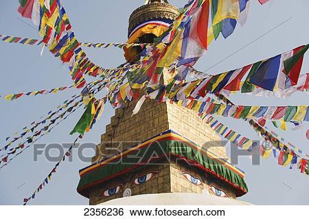 Stock Photograph - The Buddhist stupa of Boudhanath dominates the skyline and is one of the largest in the world; Boudhanath, Nepal. Fotosearch