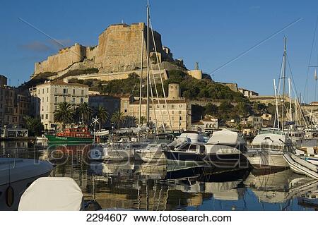 Stock Photo - The citadel rises above the harbour of Bonifacio. Corsica. France. Fotosearch