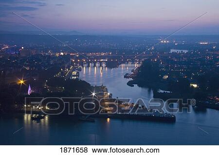 Stock Photo - The City Illuminated At Sundown; Koblenz, Rheinland-Pfalz, Germany. Fotosearch