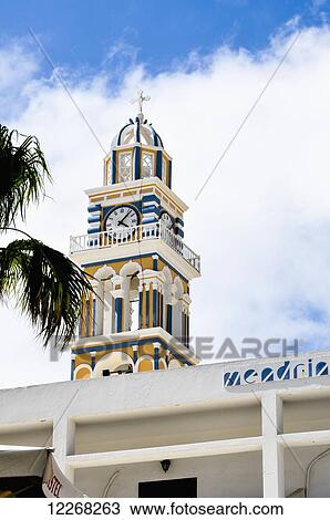 Stock Image - The clock tower of Saint John the Baptist Catholic Church; Thera, Santorini Island, Greece. Fotosearch