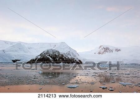 The Coastline Reflected In The Tranquil Water At Sunset; Antarctica View Large Photo Image Stock Image - The Coastline Reflected In The Tranquil Water At Sunset; Antarctica. Fotosearch