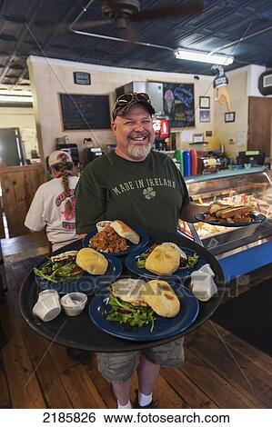 The Cowboy Gelato Restaurant Owner Jim Anderson Serving A Selection Of Homemade Burgers And Sandwiches, Route 66, Amarillo, Usa View Large Photo Image Stock Photograph - The Cowboy Gelato Restaurant Owner Jim Anderson Serving A Selection Of Homemade Burgers And Sandwiches, Route 66, Amarillo, Usa. Fotosearch