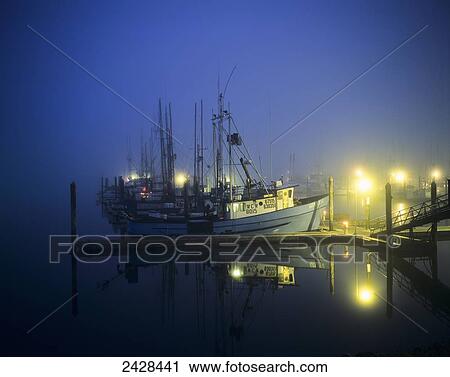 Stock Image - The docks are lit before daylight; Charleston, Oregon, United States of America. Fotosearch