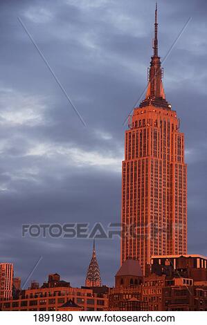 Stock Image - The Empire State Building With Chrysler Building In Background At Sunset. Fotosearch