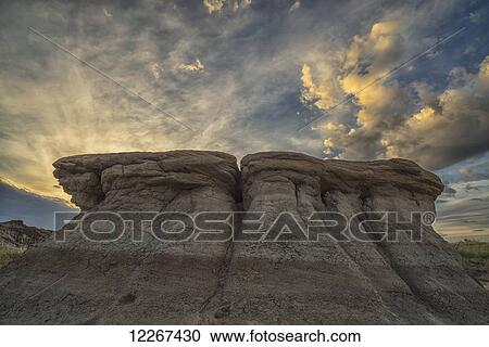 Stock Image - The erosion around Drumheller, Alberta, forming interesting formations and hoodoos in Dinosaur Provincial Park at sunset; Alberta, Canada. Fotosearch