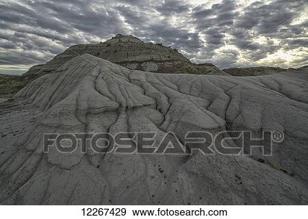 The erosion around Drumheller, Alberta, forming interesting formations and hoodoos in Dinosaur Provincial Park at sunset; Alberta, Canada View Large Photo Image Stock Photo - The erosion around Drumheller, Alberta, forming interesting formations and hoodoos in Dinosaur Provincial Park at sunset; Alberta, Canada. Fotosearch