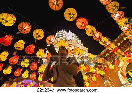 The fantastic lighting of Kek Lok Si Temple and a tourist with a camera; Penang, Malaysia View Large Photo Image Stock Photo - The fantastic lighting of Kek Lok Si Temple and a tourist with a camera; Penang, Malaysia. Fotosearch