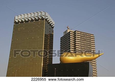 The Flamme D'or Building By Architect Philippe Starck On The Banks Of The Sumida-Gawa River, Tokyo, Japan View Large Photo Image Stock Photography - The Flamme D'or Building By Architect Philippe Starck On The Banks Of The Sumida-Gawa River, Tokyo, Japan. Fotosearch