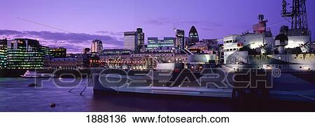 Stock Photograph - The Former British Cruiser Hms Belfast, Now Preserved As A Museum, Viewed From The Southbank, With The City Of London In The Background.. Fotosearch
