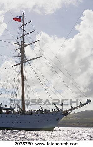 Stock Image - The Four-Mast Barquentine, Chilean Navy Training Ship Esmeralda In Hanga Roa Harbour, Rapa Nui (Easter Island), Chile. Fotosearch