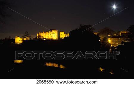 The Full Moon Shining Brightly Over A Town Illuminated At Night; Alnwick Northumberland England View Large Photo Image Stock Image - The Full Moon Shining Brightly Over A Town Illuminated At Night; Alnwick Northumberland England. Fotosearch