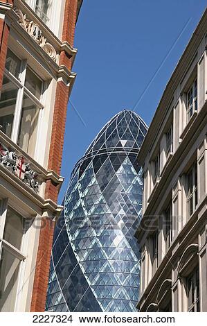 Picture - The Gerkin Flanked By Old Buildings, The City Of London, Uk.. Fotosearch