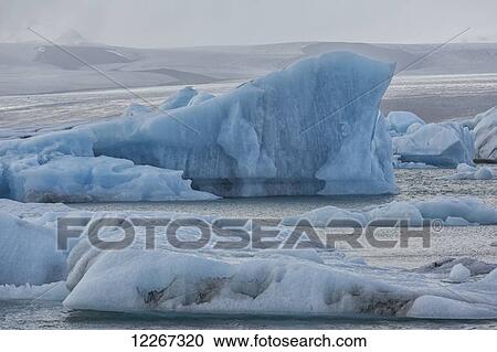 Stock Image - The glacial lagoon Jokulsarlon is full of icebergs waiting to be washed out to the ocean on the south coast of Iceland; Iceland. Fotosearch