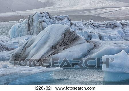 Stock Image - The glacial lagoon Jokulsarlon is full of icebergs waiting to be washed out to the ocean on the south coast of Iceland; Iceland. Fotosearch