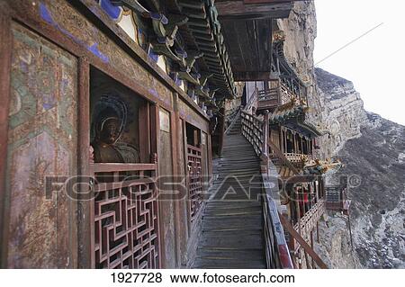 The Hanging Monastery, Built On Stilts On The Side Of A Cliff Is A Buddhist Monastery, Northern Mountain, Heng Shan, Hunyuan, Shanxi, China View Large Photo Image Stock Photo - The Hanging Monastery, Built On Stilts On The Side Of A Cliff Is A Buddhist Monastery, Northern Mountain, Heng Shan, Hunyuan, Shanxi, China. Fotosearch