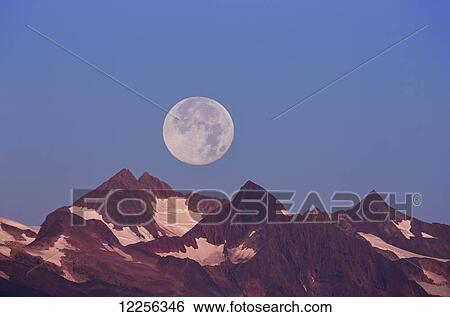 The Harvest Moon (September Moon) rises above the Chilkat mountains near Juneau, Southeast Alaska View Large Photo Image Stock Photograph - The Harvest Moon (September Moon) rises above the Chilkat mountains near Juneau, Southeast Alaska. Fotosearch