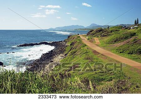 Stock Image - The Kauai multi-use path that runs alongside the shore and the Kuhio Highway; Kauai, Hawaii, United States of America. Fotosearch