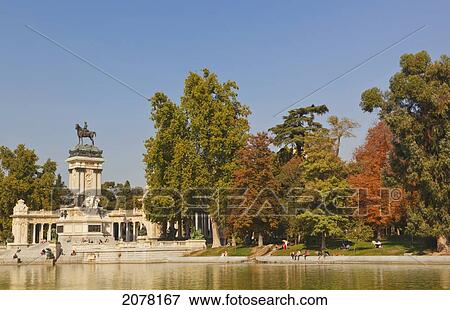 The Lake In El Retiro Gardens With The Monument To King Alfonso Xii In Background; Madrid Spain View Large Photo Image Stock Photo - The Lake In El Retiro Gardens With The Monument To King Alfonso Xii In Background; Madrid Spain. Fotosearch