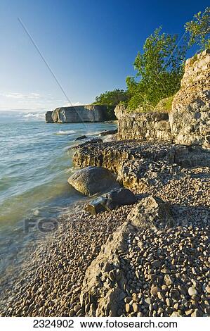 Stock Image - The limestone cliffs of Steep Rock along Lake Manitoba; Manitoba, Canada. Fotosearch