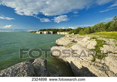 Stock Photo - The limestone cliffs of Steep Rock along Lake Manitoba; Manitoba, Canada. Fotosearch