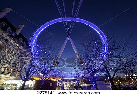 Stock Image - The London Eye spinning at dusk; London, England. Fotosearch
