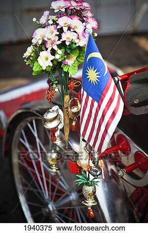 Stock Photography - The Malaysian Flag Flying On The Side Of The Traditional Bicycle Rickshaw; Penang Malaysia. Fotosearch