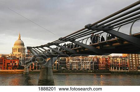 Stock Image - The Millennium Bridge Stretching Across The River Thames To St Pauls Cathedral. Fotosearch