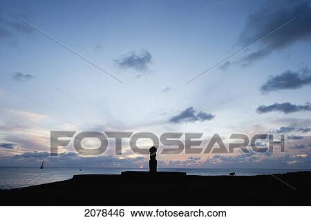 Stock Photograph - The Moai Of Ahu Ko Te Riku At The Tahai Ceremonial Complex Statue, Restored By William Mulloy Is The Only Statue To Feature Inlaid Eyes. Hubert Herzog And Tony Saulnier Had The Pukao (Top Knot) Cut And Put In Place, Rapa Nui (Easter Island), Chile. Fotosearch