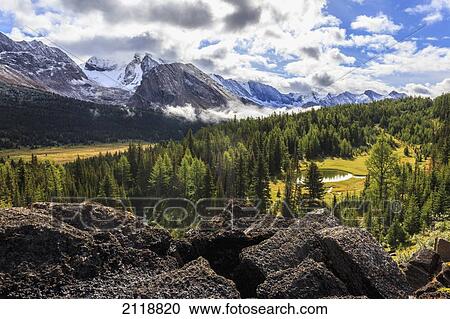 Stock Image - The Morning Sun Clears The Valley Mist Near Baker Lake In The Skoki Wilderness Area Of Banff National Park; Alberta Canada. Fotosearch