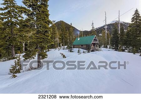 Stock Photo - The Morning Sun Illuminates Edwards Lake Cabin In Tetrahedron Provincial Park; British Columbia Canada. Fotosearch