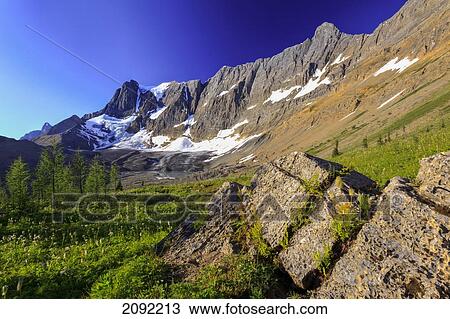 Stock Image - The Morning Sun Over The Rockwall Cliff And Tumbling Glacier In Kootenay National Park; British Columbia Canada. Fotosearch