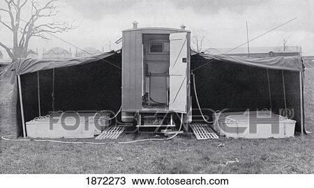 Stock Image - The Motor Bath, A Portable Bath System Used By Both Wounded And Active British Soldiers Behind Teh Front During World War One. From The Illustrated War News Published 1915. Fotosearch