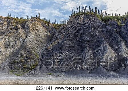 The mountain aptly named Fold Mountain lies along the banks of the Porcupine River; yukon, Canada View Large Photo Image Stock Image - The mountain aptly named Fold Mountain lies along the banks of the Porcupine River; yukon, Canada. Fotosearch