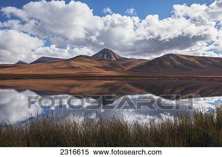 Stock Photography - The Mountains Along The Dempster Highway Reflected In An Unnamed Pond In Autumn; Yukon Canada. Fotosearch